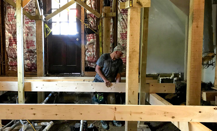 the lead carpenter inspecting the construction site in the built-in wooden frames